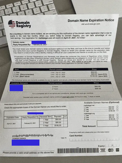 A document from the "Domain Registry of America" with a blue label on it is sitting on a desk.