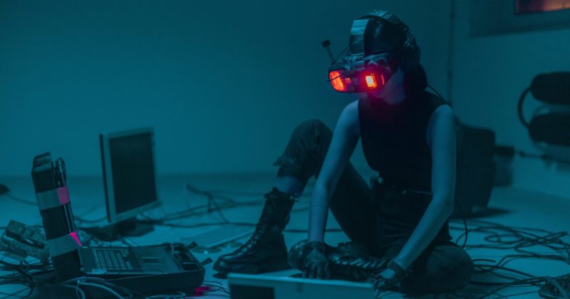 A woman enjoying virtual reality with a laptop.