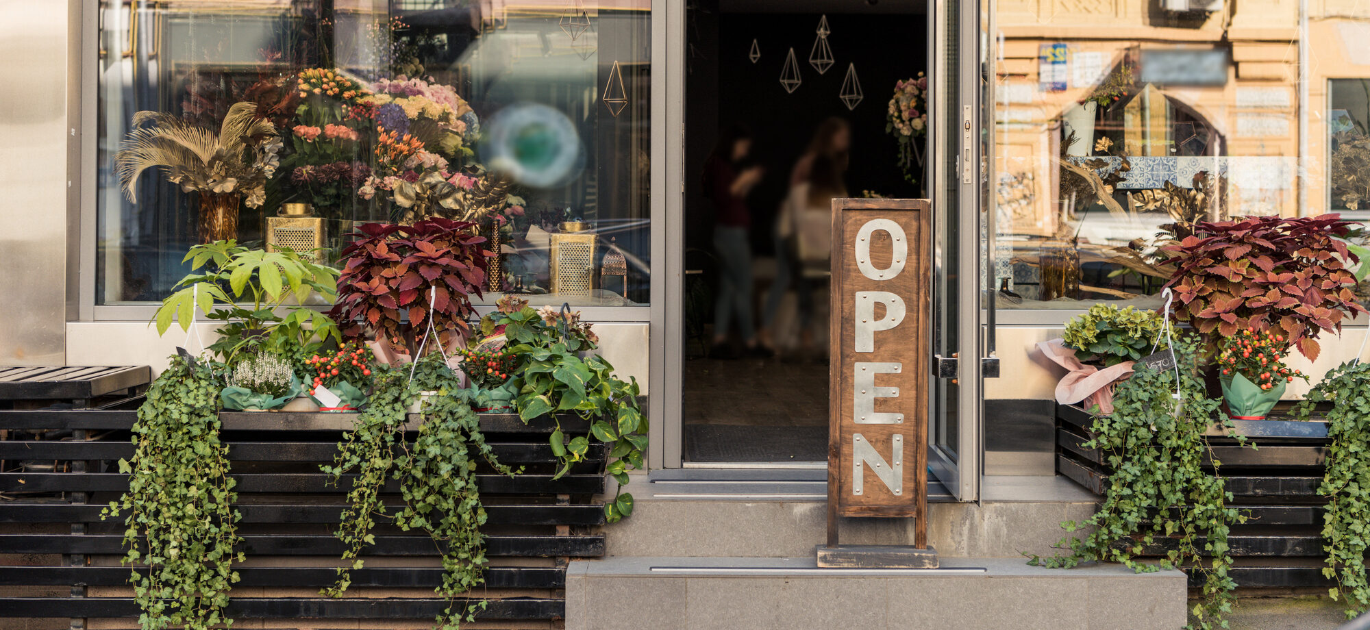 A beautifully crafted wooden sign exquisitely displaying the store's branding with precision and finesse.