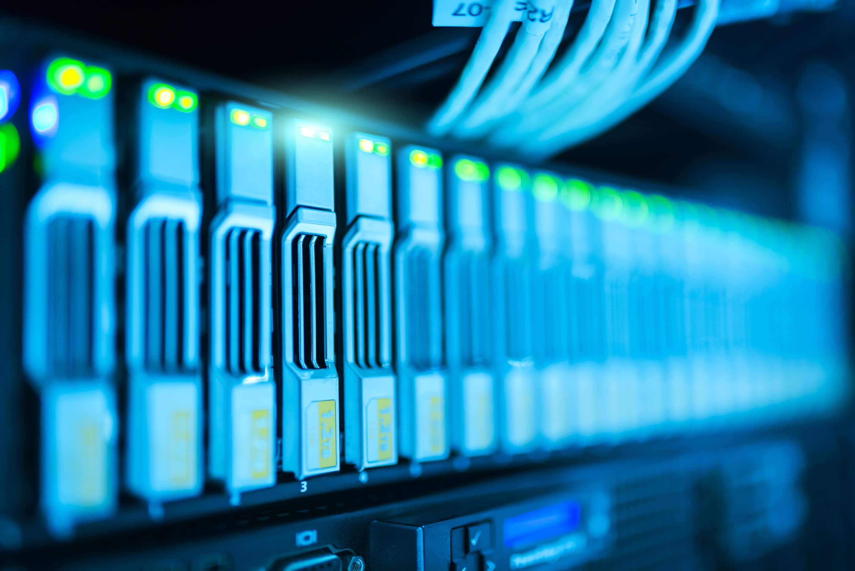 A close up of a server rack in a data center, highlighting the intricate web of technology.