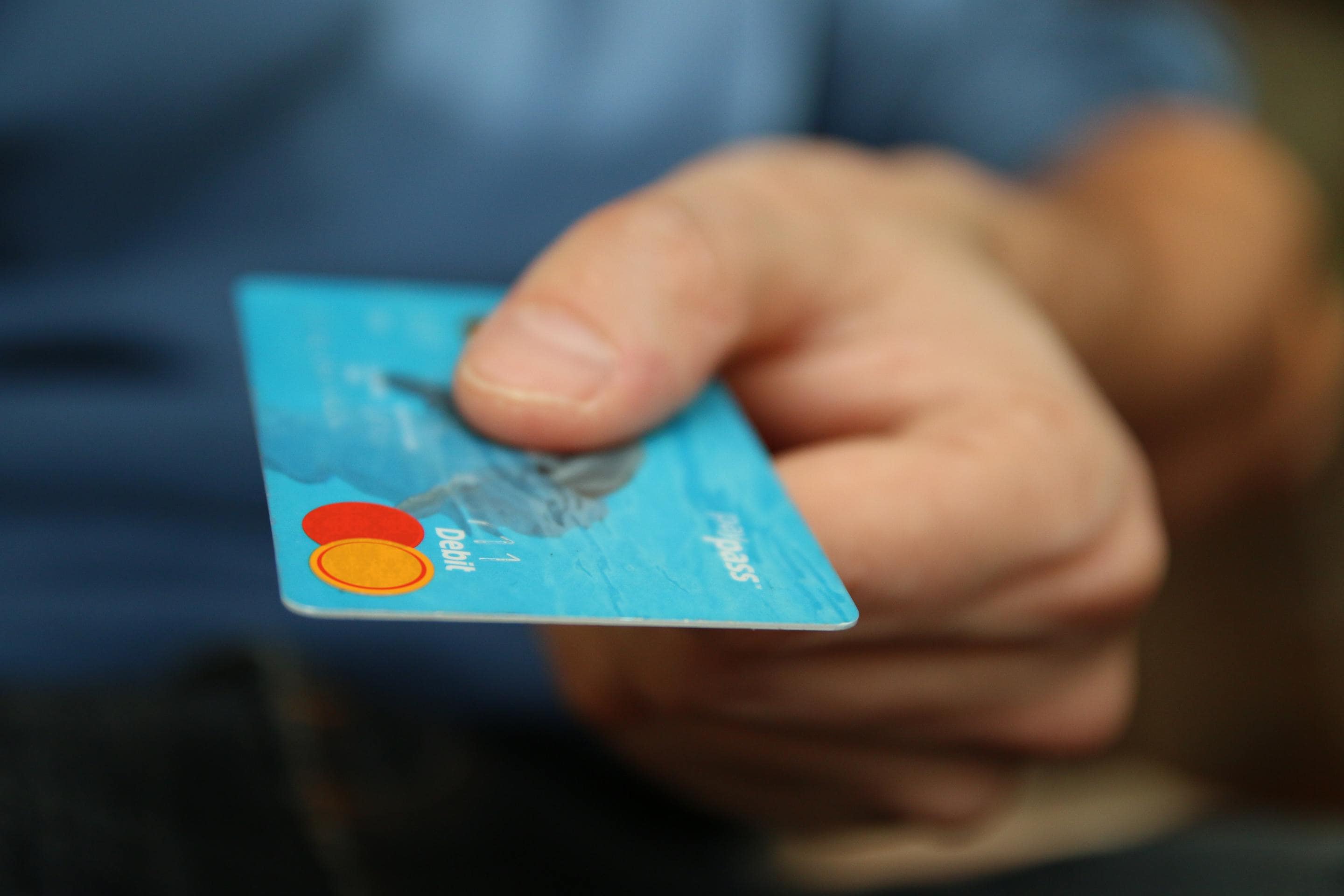 A person engaged in ecommerce holding a credit card.