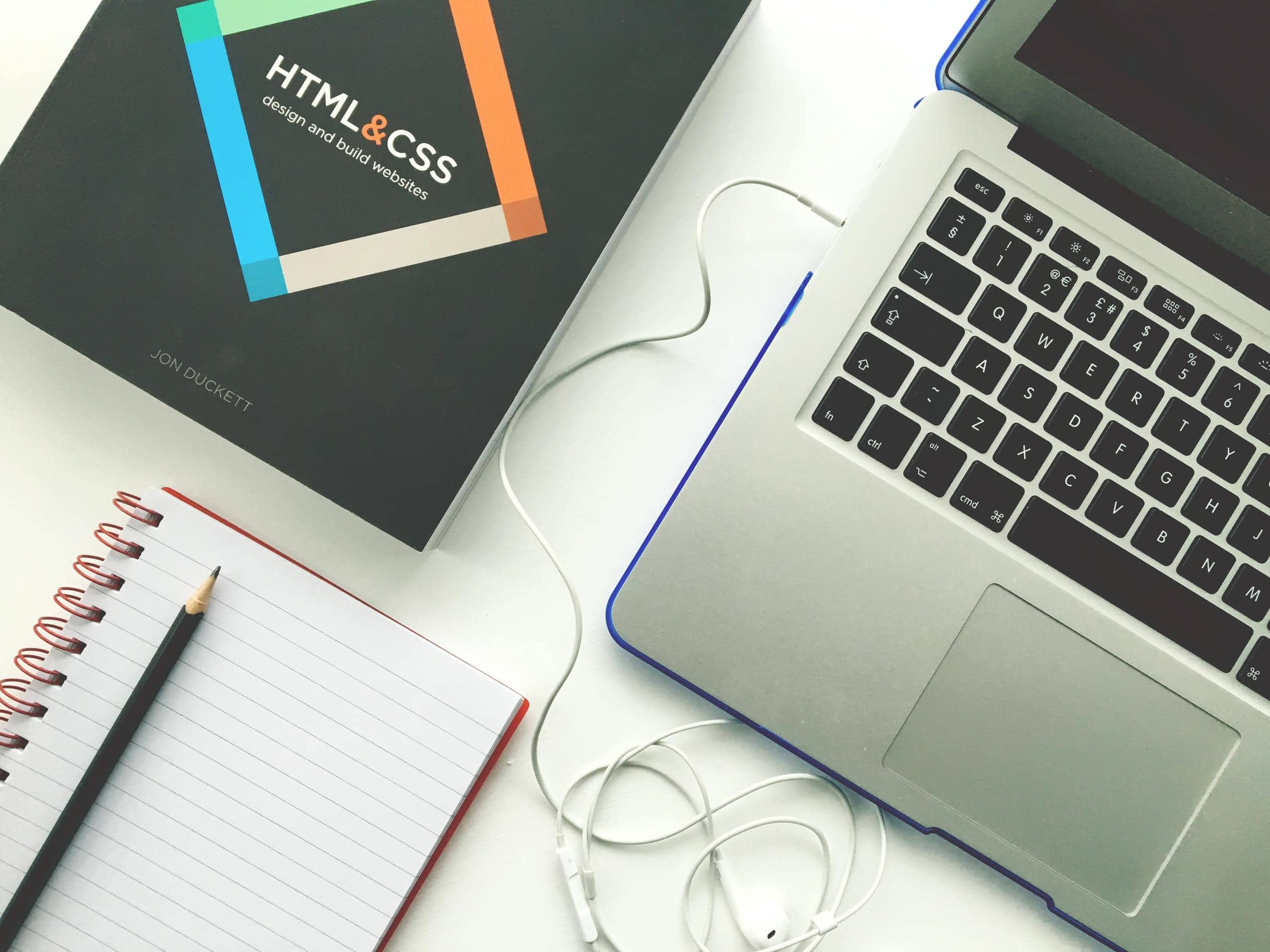 A website design featuring a laptop and earphones.
