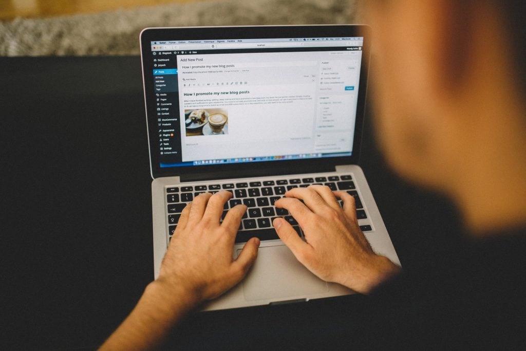 A person typing on a laptop computer.