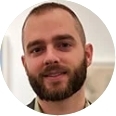 A man with a beard is smiling in a circle.