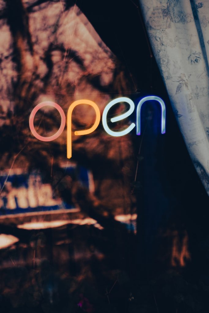 A neon sign advertising local SEO services with the word open displayed prominently.