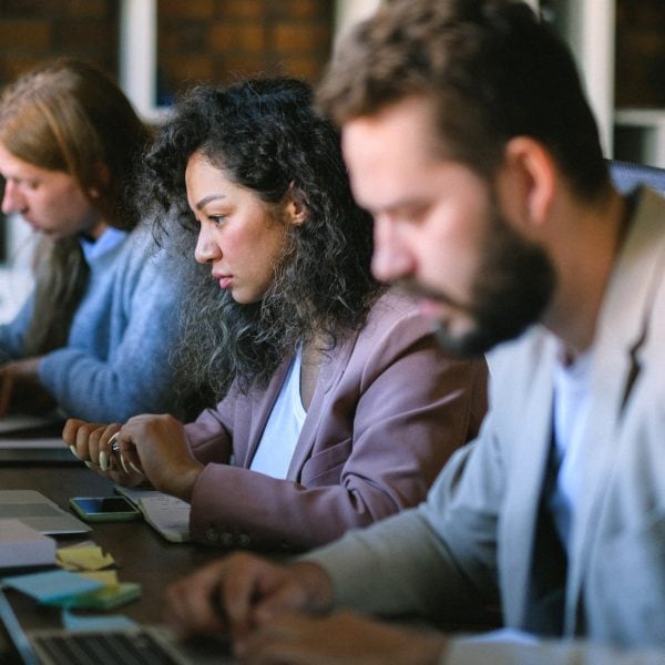 A team of professionals utilizing laptops in a office setting.