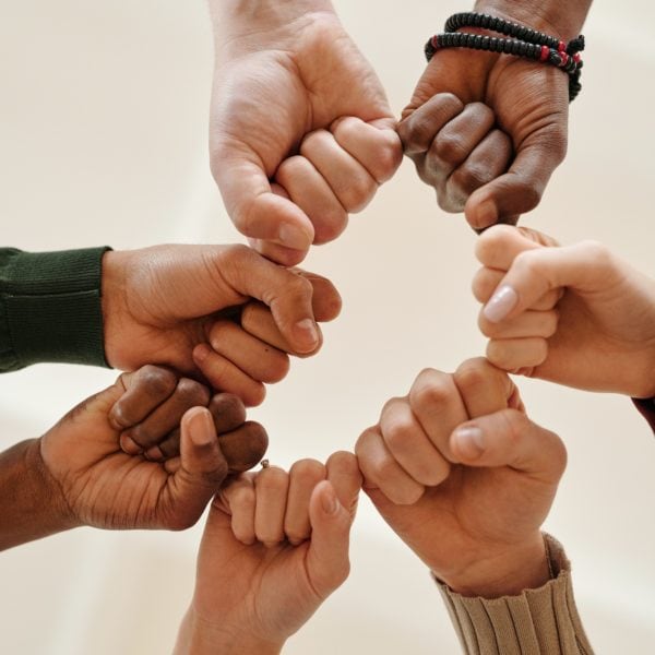 A circle of individuals forming a human chain in support of nonprofits.