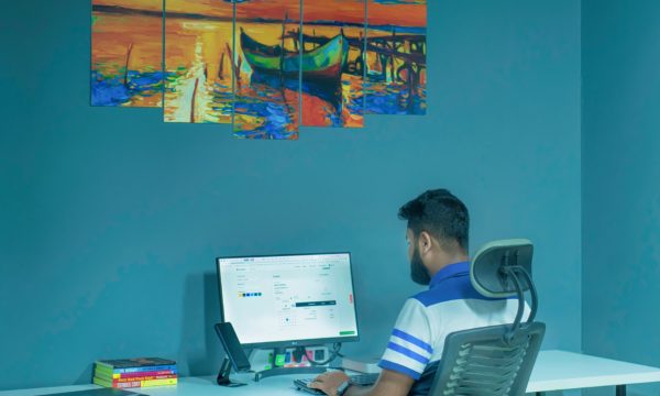 A man at a desk in a library.