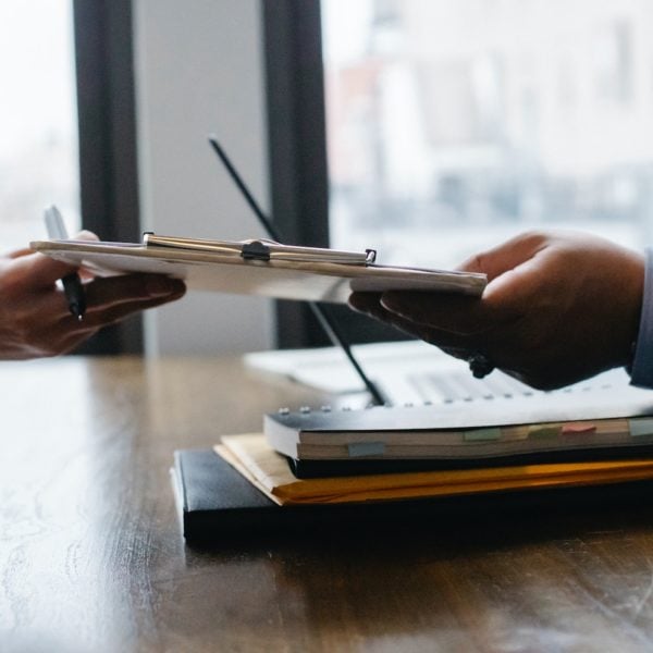 Recruiters exchanging document at a desk.