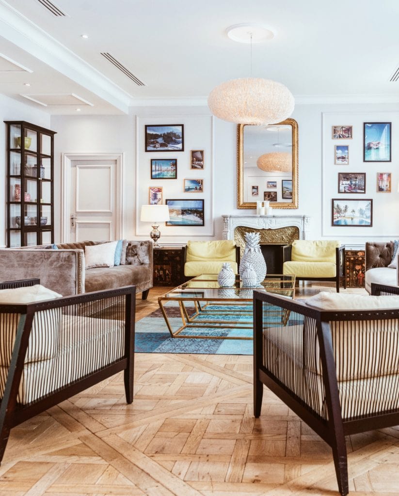 A stylish living room featuring a carefully curated arrangement of couches, chairs, and a coffee table showcasing impeccable interior design.