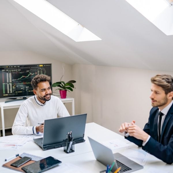 A group of IT professionals and MSP executives sitting at a table in an office.