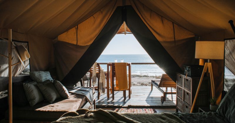 A  room in a tent with an ocean view featured on one of the 22 Best Travel Agency & Tourism Websites.