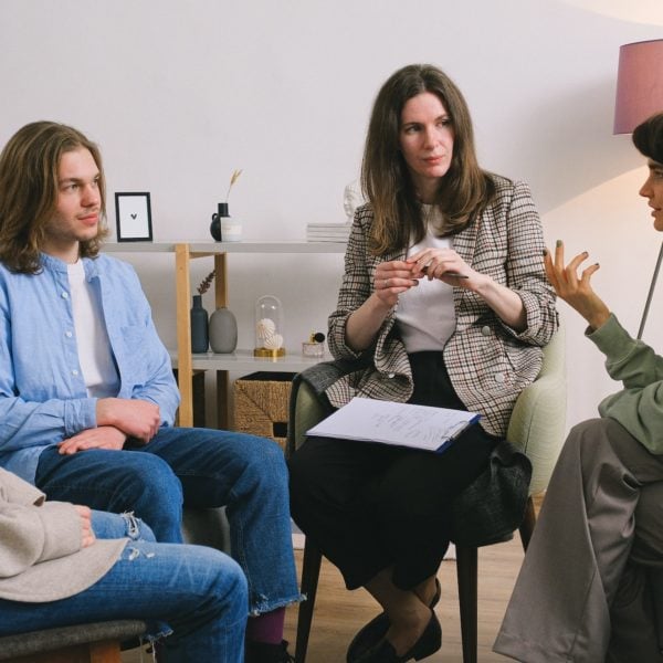 A group of female consultants engaging in conversation within a room.