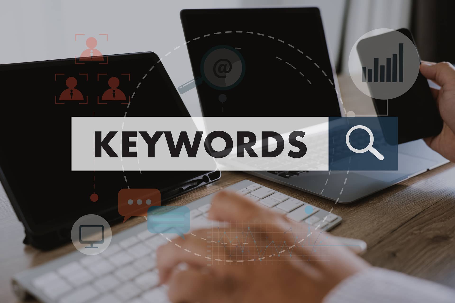 A person learning Keywords 101 in Digital Marketing by typing on a laptop with the words "keywords" on it.