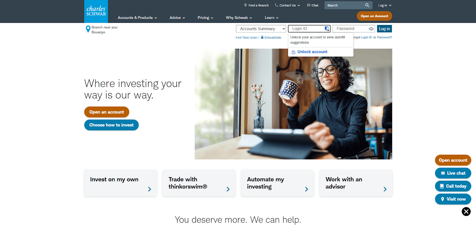 A woman in glasses sits at a desk with a mug and laptop, smiling and pointing at the screen. The Charles Schwab website design surrounds her with options to open an account, invest, and build trust in top-tier financial services.