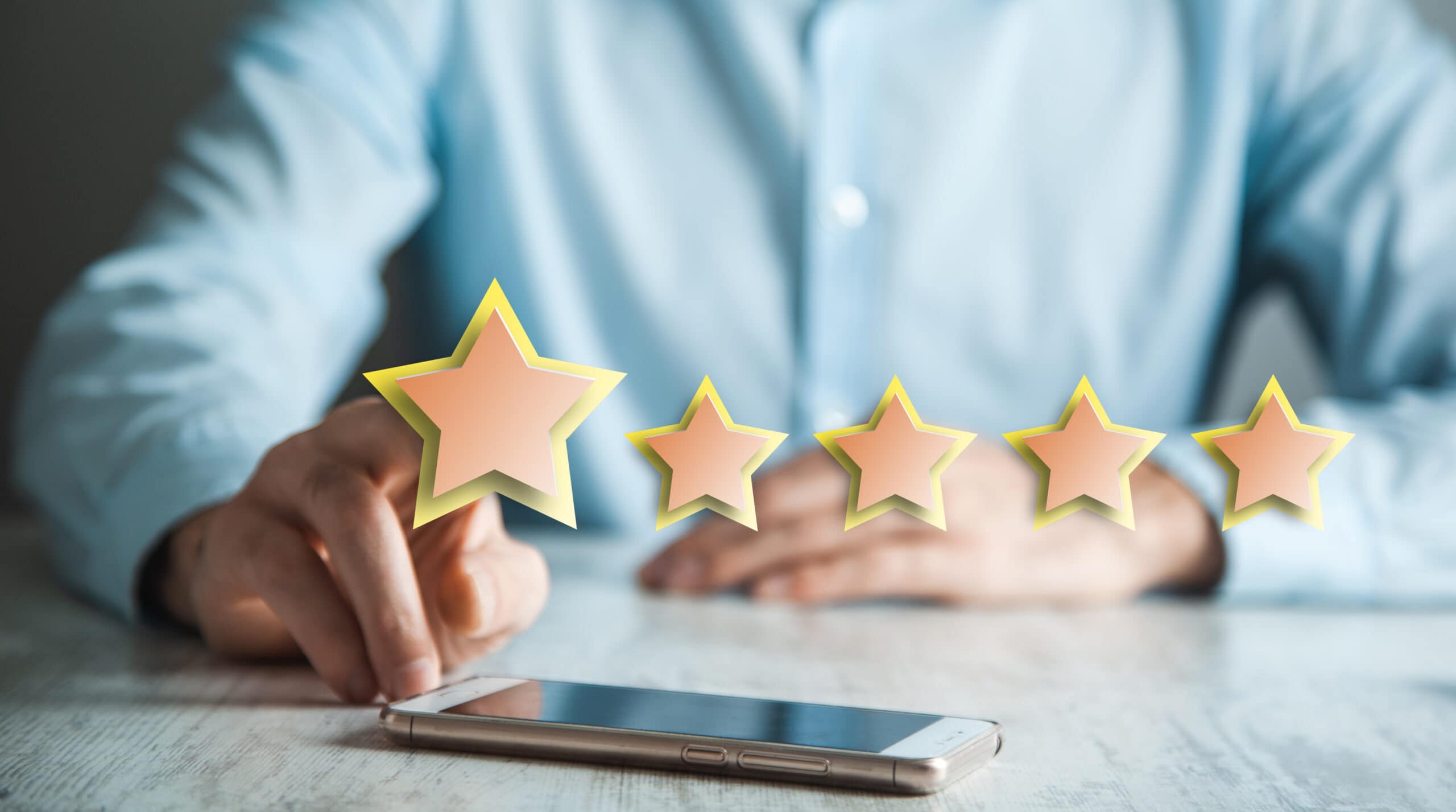 A man holding a phone with Google Reviews on it.