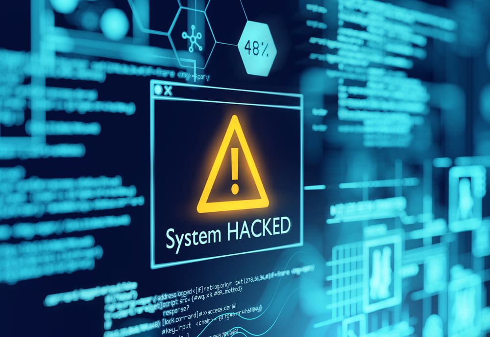 A computer screen displaying a system hacked sign highlighting the threat of pwned passwords.