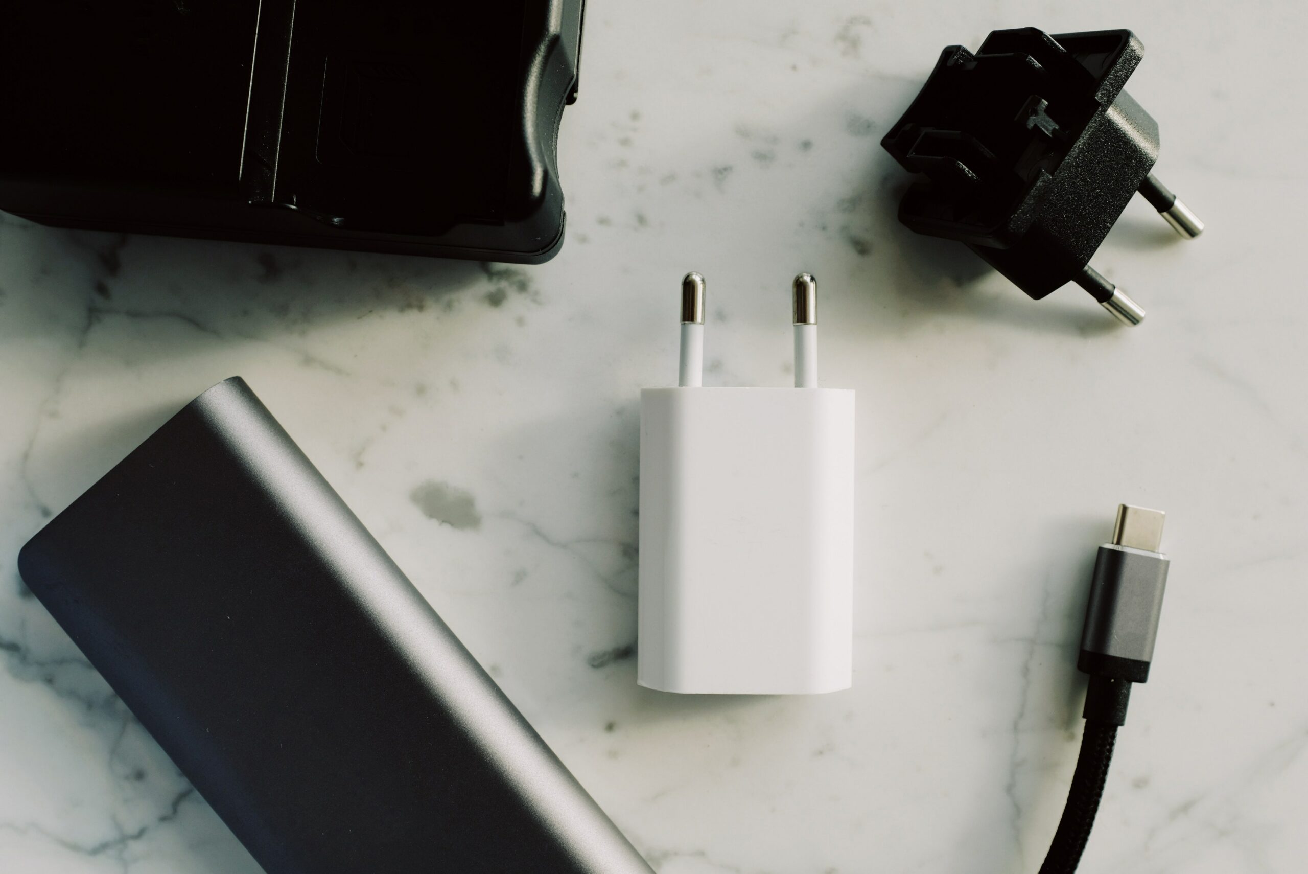 A collection of chargers and cables presented on a sleek marble table.