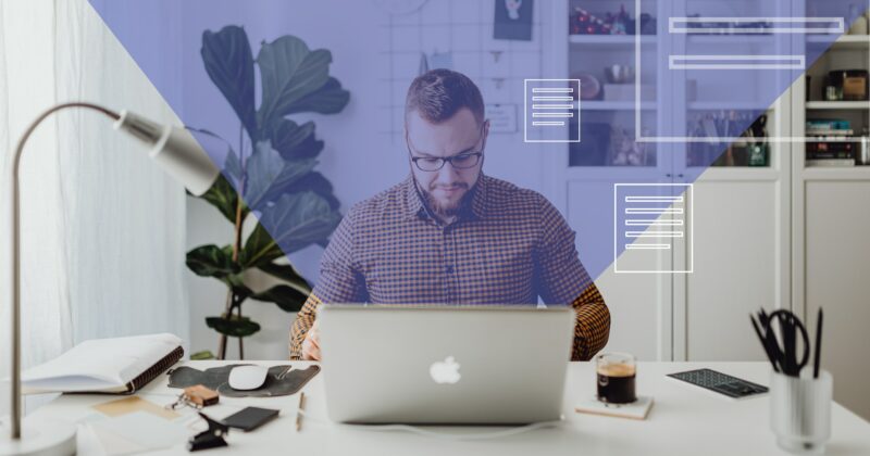 A man at a desk with a laptop, strategically working on the website.