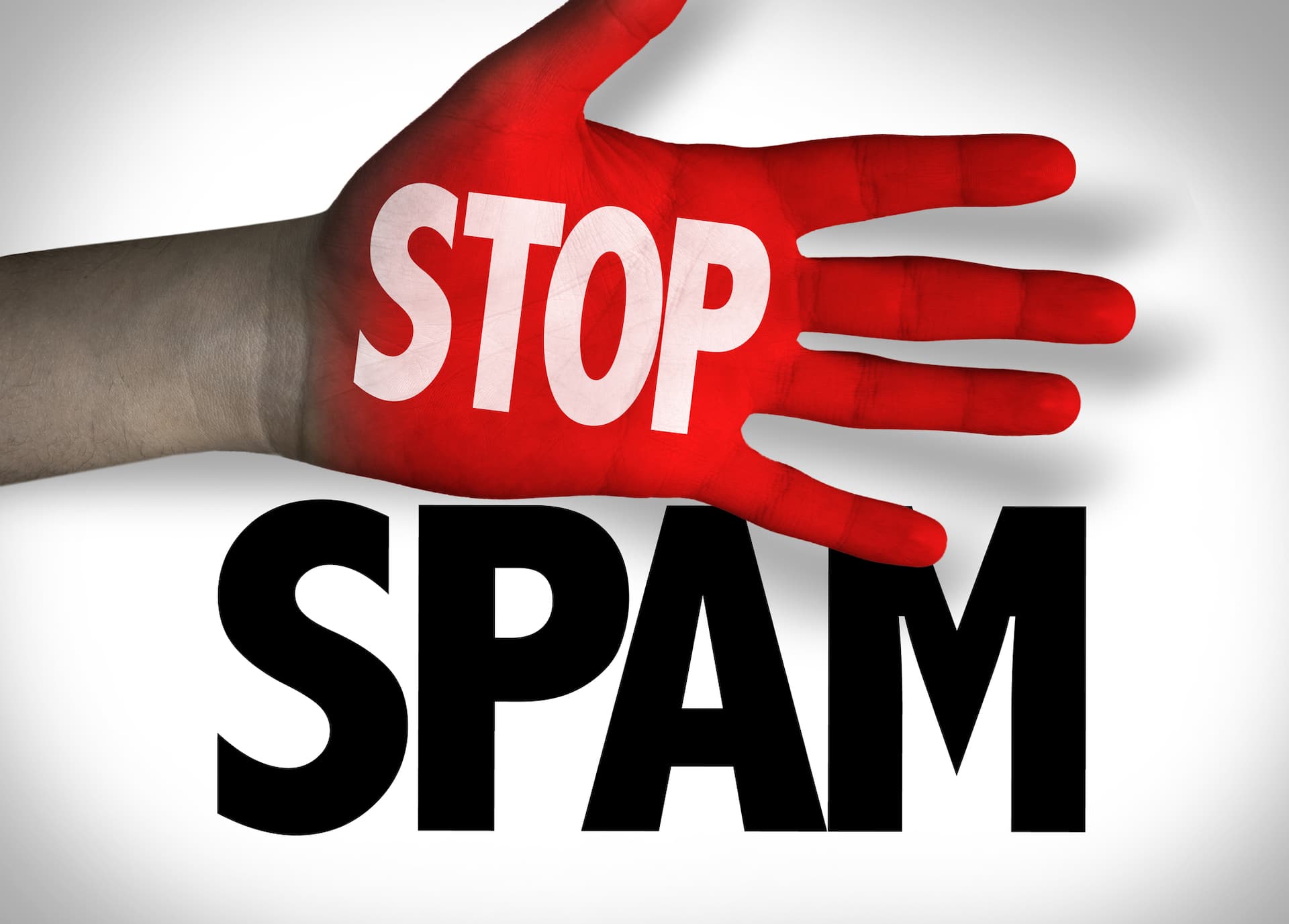 A hand displaying the word "stop spam" representing compliance with the CAN SPAM Act, U.S. anti-spam laws.