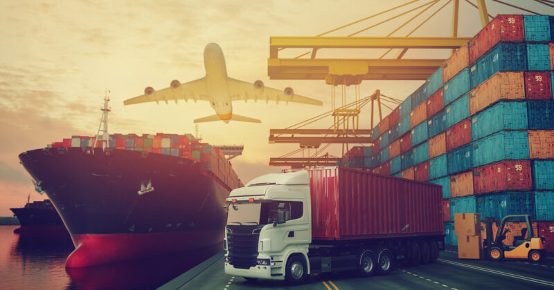 A truck near a container ship.