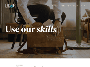 A business website with a man sitting on the floor.