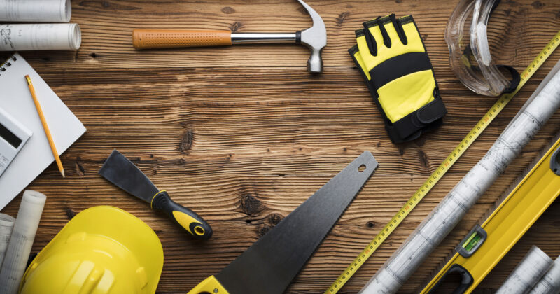 A general contractor's construction tools on a table.