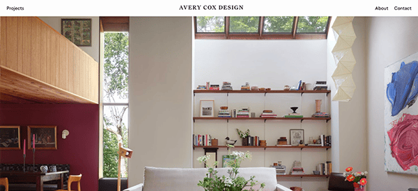 A living room with a white couch and bookshelves.