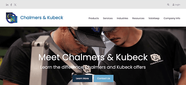 Two technicians examining equipment with focus, with a website banner for chalmers & kubeck in the background inviting visitors to learn more about the company.