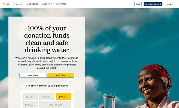 A screenshot of the charity: water website featuring a campaign for clean and safe drinking water with an image of a smiling individual in the background.