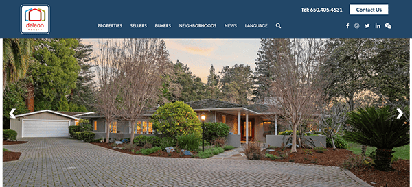 Elegant suburban home with a landscaped front yard and a driveway leading to a double garage at dusk.