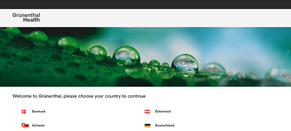 Water droplets on a green leaf with a website navigation menu offering country choices for a health company.