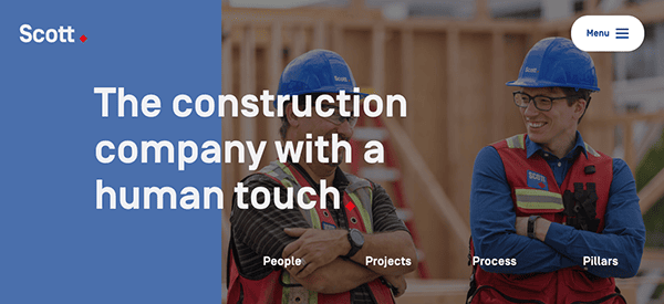 Two construction workers in hard hats smiling and talking on a construction site with promotional text for a construction company that emphasizes its human touch.