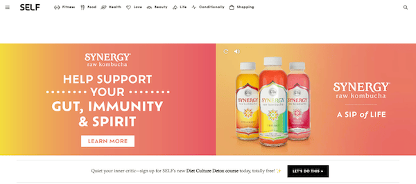 Website banner promoting synergy raw kombucha drinks, highlighting their health benefits for gut, immunity, and spirit, featuring images of the product bottles against a two-tone background.