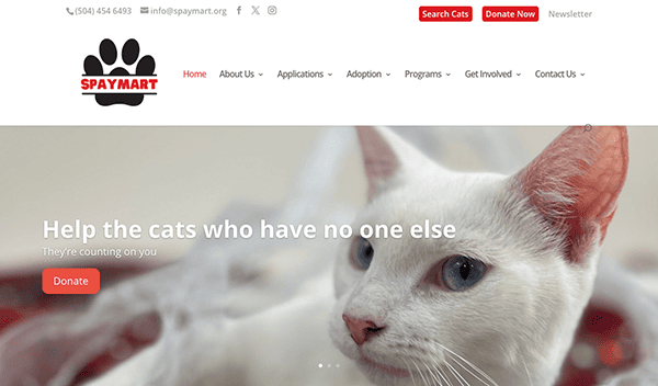 Website header for "spaymart" featuring a close-up of a white cat with the tagline "help the cats who have no one else" and a "donate" button.