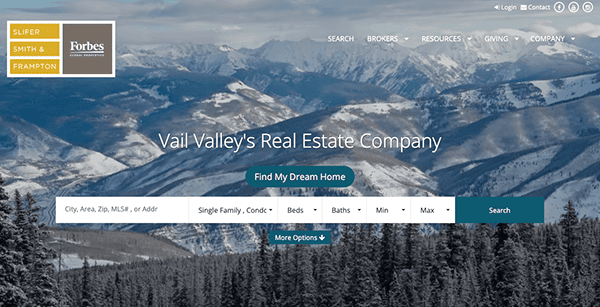 A screenshot of a real estate company's homepage with a background image of a snowy mountain range.