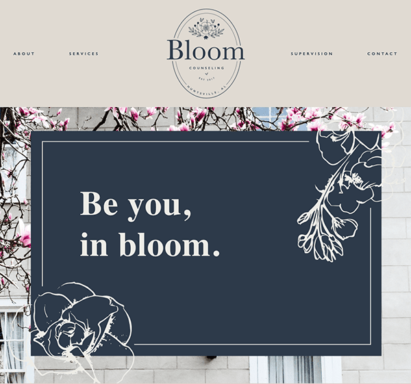 A website banner for bloom consulting, featuring a slogan "be you, in bloom." overlaid on a dark floral background, complemented by pink blossoms in the upper corners.
