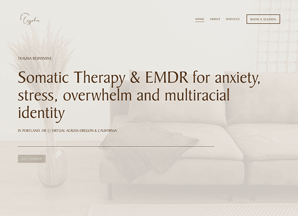 Website homepage for a therapy service offering somatic therapy and emdr, featuring an elegant white-themed setting with a couch and pillow.