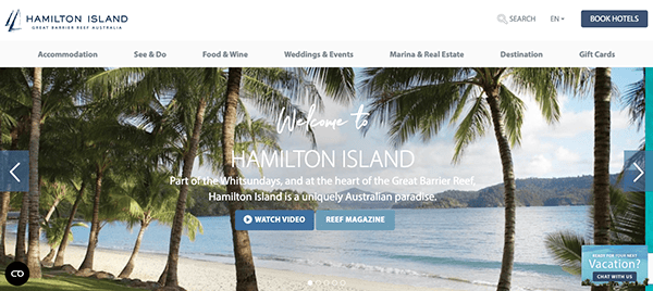 Website banner for hamilton island featuring palm trees, ocean view, and a "welcome to hamilton island" text overlay.