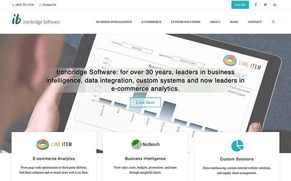 A person views the ironbridge software website on a laptop, showcasing services like business intelligence and custom systems.