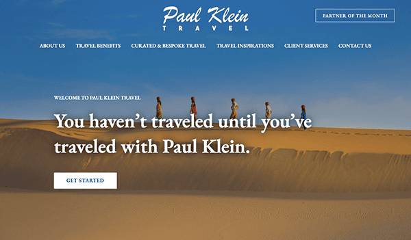 Website homepage for paul klein travel featuring a banner image of a line of people walking along a desert dune under a blue sky.