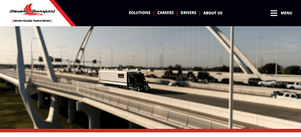 A website banner featuring a blurred image of a cable-stayed bridge with a clear focus on a white semi-truck driving on the highway.