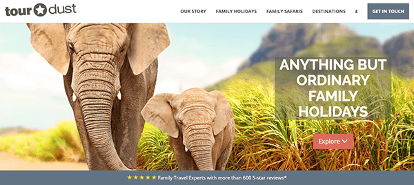 Website banner showing the rear view of an adult and a baby elephant walking away, with text promoting unique family holidays by "tourdust.