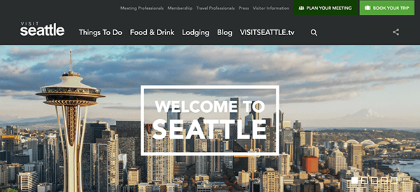 Website banner for visit seattle featuring a wide shot of the seattle skyline with the space needle on the left and mount rainier in the background.