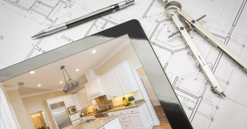 Tablet displaying a modern kitchen overlaid on architectural blueprints with a pen and compass nearby, showcasing one of the top kitchen design sites.