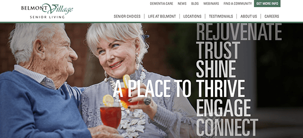 An elderly man and woman share a drink outdoors. Text reads, "Belmont Village Senior Living: Rejuvenate, Trust, Shine, A Place to Thrive, Engage, Connect.
