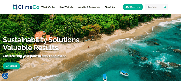 Aerial view of a lush coastline with thick forest meeting a clear blue sea, featuring a text overlay about sustainability solutions from climeco.
