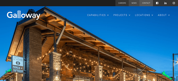 Exterior of galloway building at dusk with illuminated string lights and wooden architecture, featuring signage for a brewery taproom.