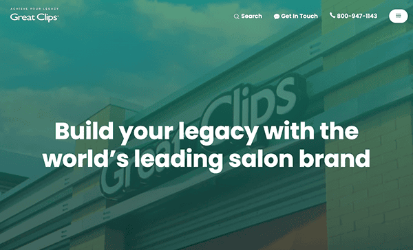 Website banner for great clips showcasing the exterior of a salon with the text "build your legacy with the world’s leading salon brand.