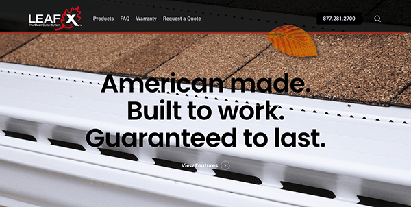 Close-up of a roof with a gutter guard system and a single leaf. Text reads: "American made. Built to work. Guaranteed to last.